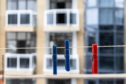 Obraz na plátně clothespins hang on rope close-up on open balcony