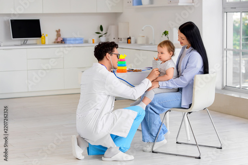 Pediatric healthcare and child wellness, doctor examining toddler with stetho...