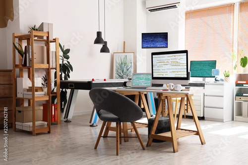 Software development and remote work, programmer workspace with computer moni...