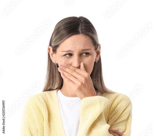Fotografie Disgust and bad smell concept, young woman covering her nose and mouth with hand