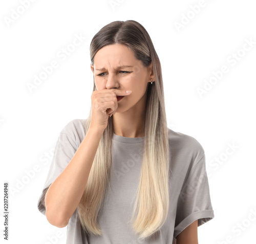 Fotografie Bad smell and disgust, young woman covering nose with hand to avoid unpleasant o