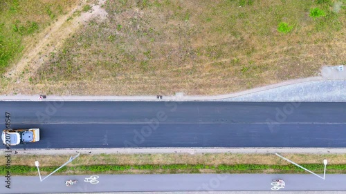Aerial View of Road Construction with Asphalt Paver and Roller Compacting New Pavement
