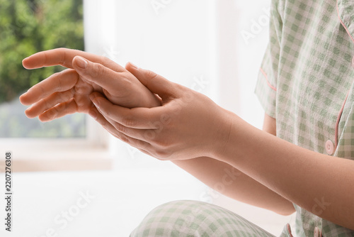 Joint pain and arthritis relief, woman massaging sore hand to soothe inflamma...