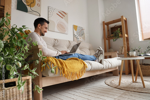 Remote work and digital nomad lifestyle, happy man working on a laptop while ...