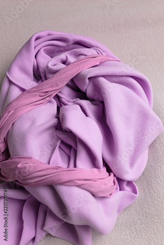 Purple fabric draping in folds. Fabric texture background.