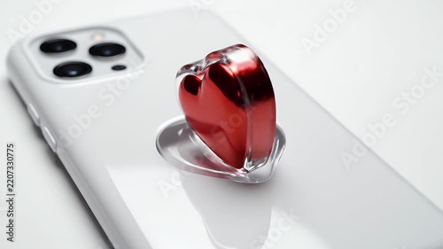 Bright White Smartphone With a Red Heart Sticker on Its Back in Soft Studio Lighting