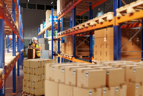 Warehouse logistics, worker handles cardboard boxes and organizes goods on pallet racks during order picking, inventory management and distribution.