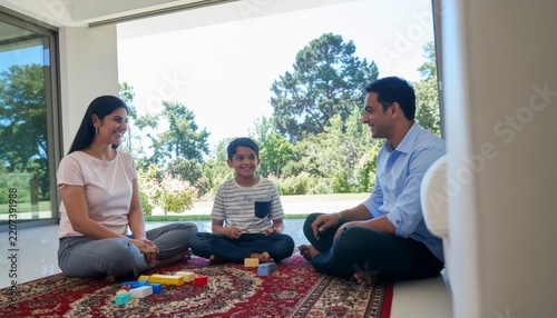 Family enjoying leisure time together in a modern living room.
