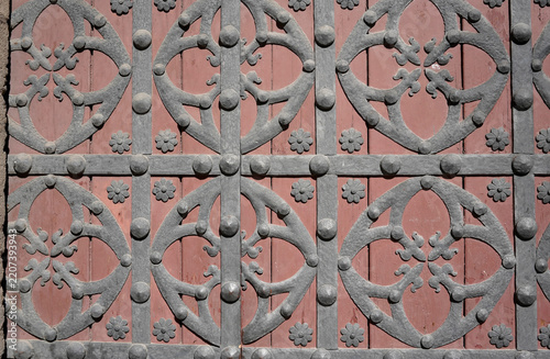 Ornate ironwork gate on wooden door
