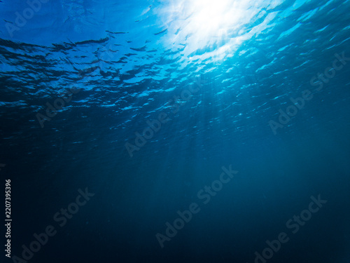 Sunlight filters down through blue ocean in the Caribbean
