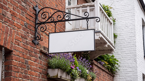 Mockup Blank hanging sign on brick wall with flower box mockup