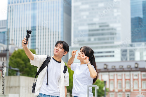 Asian tourists taking selfies with action cameras. Video, live streaming, inbound tourism, foreigners, social media, popular
