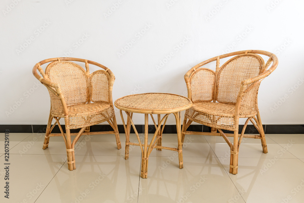 Fototapeta premium Rattan chairs and a round coffee table in a modern living room
