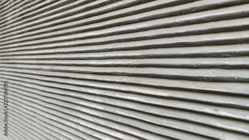 a close-up, perspective shot of a textured surface with uniform, horizontal ridges. he parallel lines run across the frame, creating a strong sense of depth and linear patterns