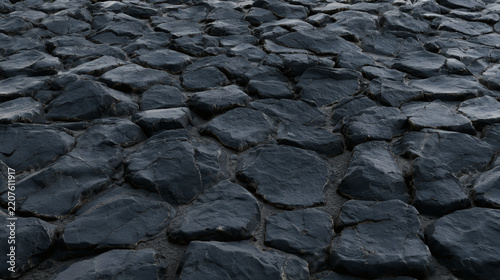 Dark blue-gray cracked stone surface with large uneven rock shapes, creating a rugged natural texture background