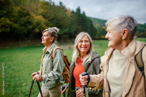 Group of mature female friends enjoying countryside walk.