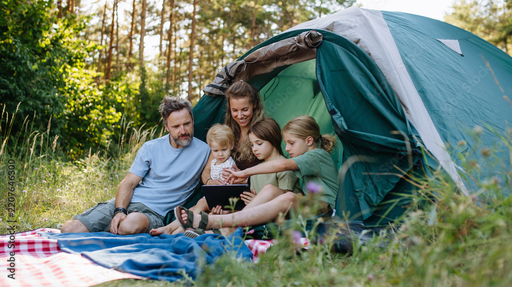 Obraz premium Happy family spending time together during summer camping trip.