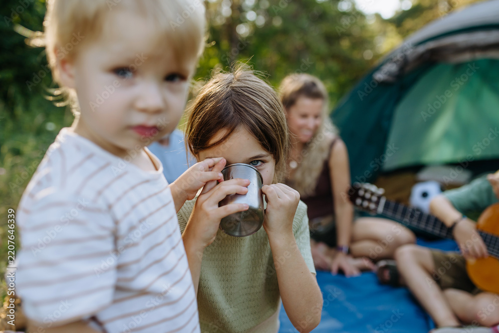 Obraz premium Happy family spending time together during summer camping trip.