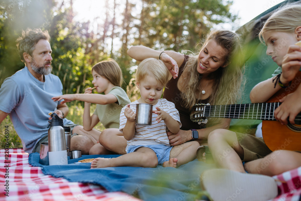 Obraz premium Happy family spending time together during summer camping trip.