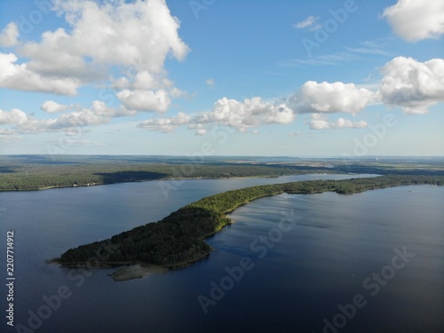 Panoramic drone view of forest islands across a northern lake
