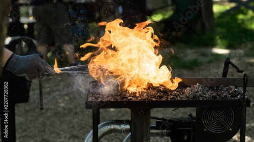 Metal Forging at a Coal Forge with Rising Flames