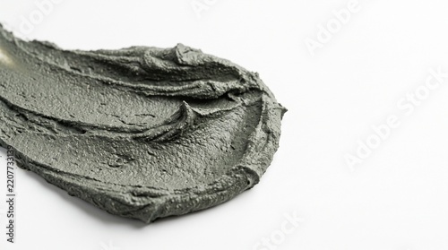 Smear of grey cosmetic clay mask texture with gritty details for facial skincare product advertisement promotion