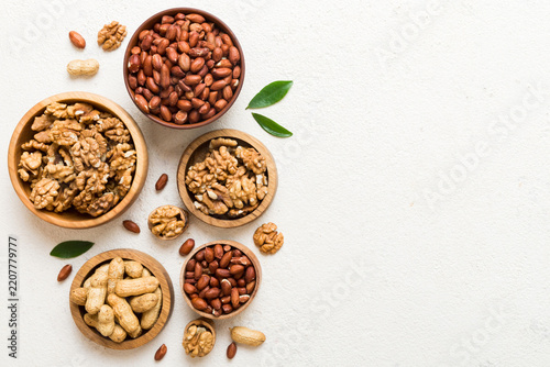 Walnut kernel halves, in a wooden bowl. Close-up, from above on colored background. Healthy eating Walnut concept. Super foods with copy space