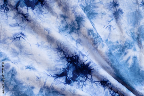 Close-up batik shirt with indigo blue dye on white fabric cotton background on top-view