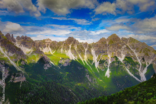 Mountain range with rugged peaks and green alpine slopes