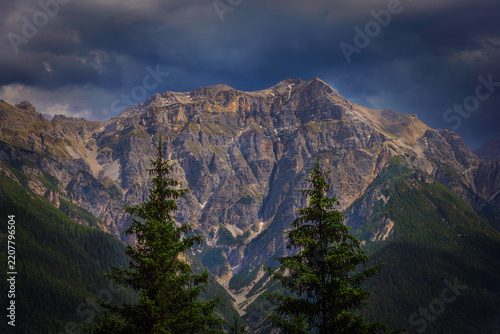 Mountain landscape with rugged peak and dark clouds