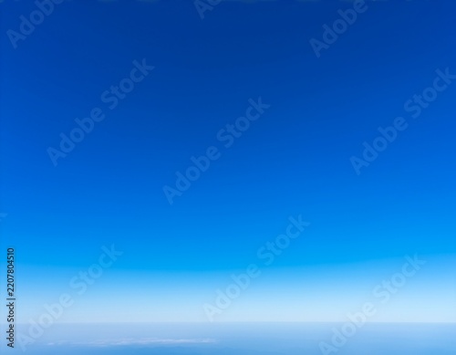 clear blue sky with light clouds and distant horizon landscape view