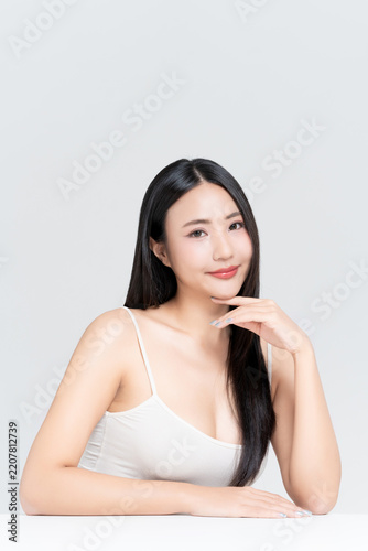Beautiful young Asian woman with glamour look, glowing face natural makeup and healthy black hair isolated on white background, for advertising about beauty clinic, skincare and cosmetics concept.