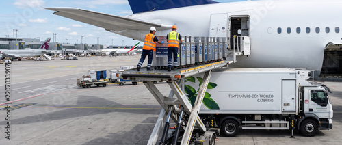 Aircraft cargo loading with ground crew and cold chain catering truck