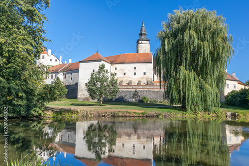 View of Telc across pond with reflections. Czech Republic. Horizontally. 