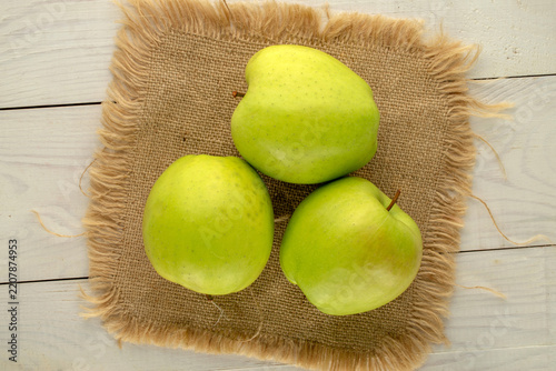 Ripe apples on a jute napkin, top view, macro.