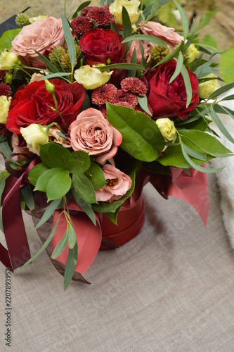 Elegant bouquet of red and pink roses with eucalyptus and delicate blossoms