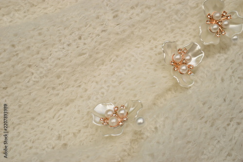 Delicate floral embellishments with pearls and crystals on soft textured fabric