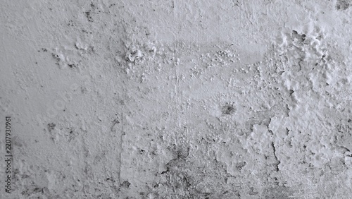 Monochrome white wall with vertical paint strokes, chipped plaster, cracks and exposed underlayers, creating a distressed architectural texture.