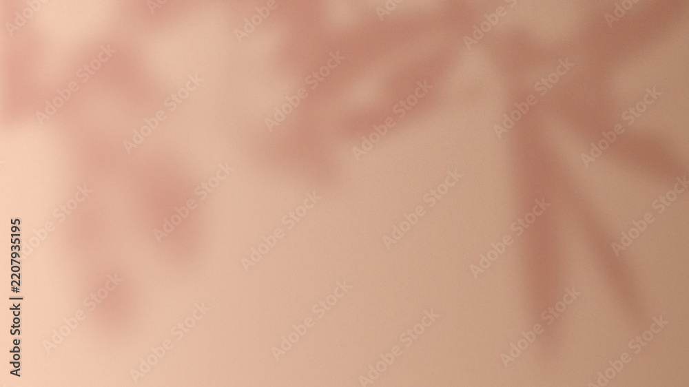 Fototapeta premium Soft pink background with blurred leaf shadows, creating a gentle, calming texture.