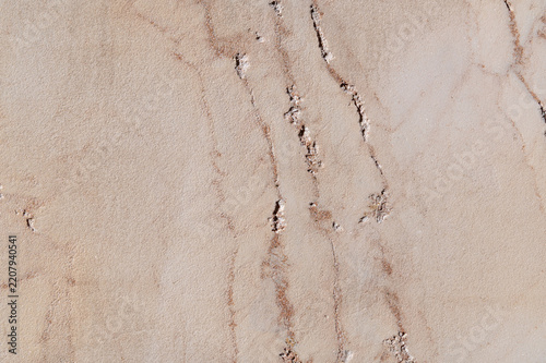 Beige marble surface with natural veins and texture closeup