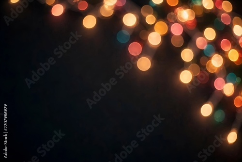 Colorful Christmas string lights bokeh on dark background