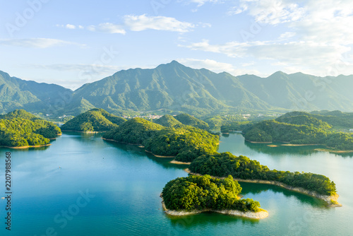 Aerial view of lush green islands in the blue waters of qiandao lake surrounded by mountains