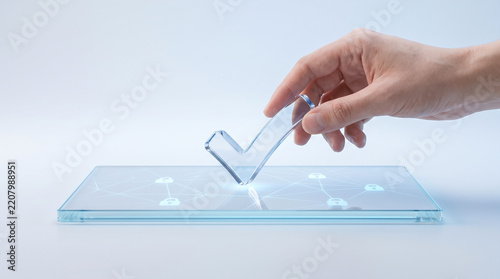 Hand placing a transparent digital checkmark on a modern touchscreen interface, representing approval, verification, selection, confirmation, and digital decision-making.