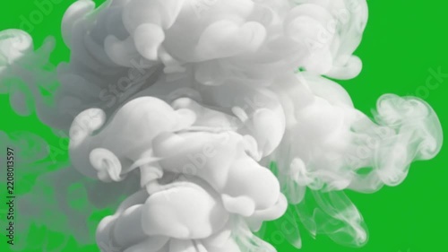 Dense rolling white clouds of swirling vapor expand across a vibrant green screen field while gaseous matter creates complex fluid motions that capture raw natural energy in this dramatic