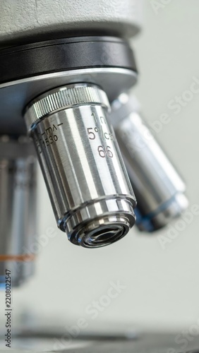 Professional laboratory microscope for scientific research and medical analysis. Modern equipment for biology experiments, cell observation, and biotechnology studies on bright background.