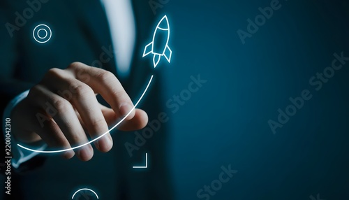 Businessman Drawing Rocket Illustration with Light on Digital Interface