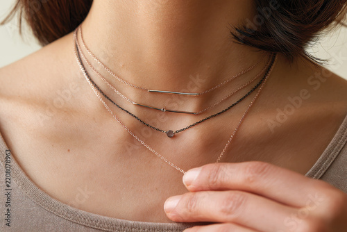 A detailed view of layered necklaces in rose gold, demonstrating the artistry behind jewelry design and its ability to elevate any outfit with elegance and charm.