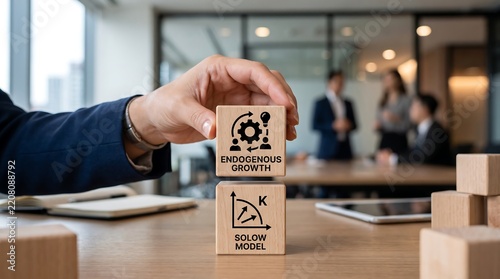 Businessman building a tower of wooden blocks featuring economic theory concepts of endogenous growth and Solow model