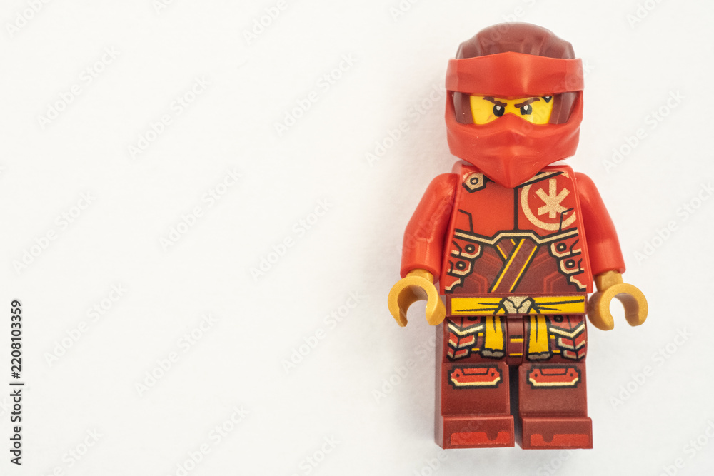 Obraz premium Close up of a Kai lego mini figure from the Ninjago series, shot isolated on a white paper background. Seen here wearing a red ninja face covering. Bradford, UK.Sep 28 2026