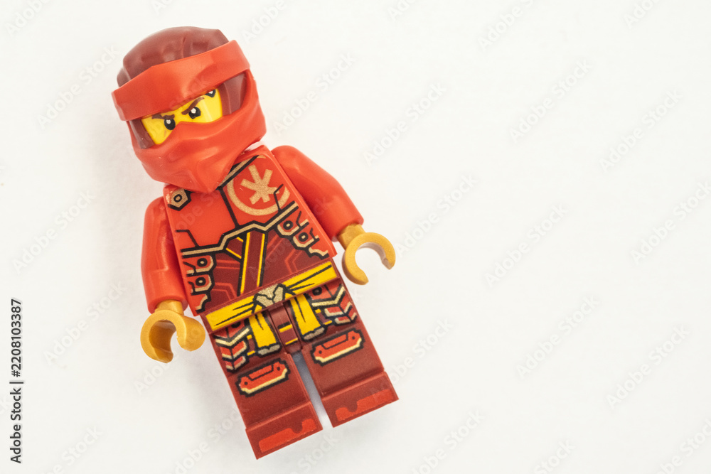 Obraz premium Close up of a Kai lego mini figure from the Ninjago series, shot isolated on a white paper background. Seen here wearing a red ninja face covering. Bradford, UK.Sep 28 2026